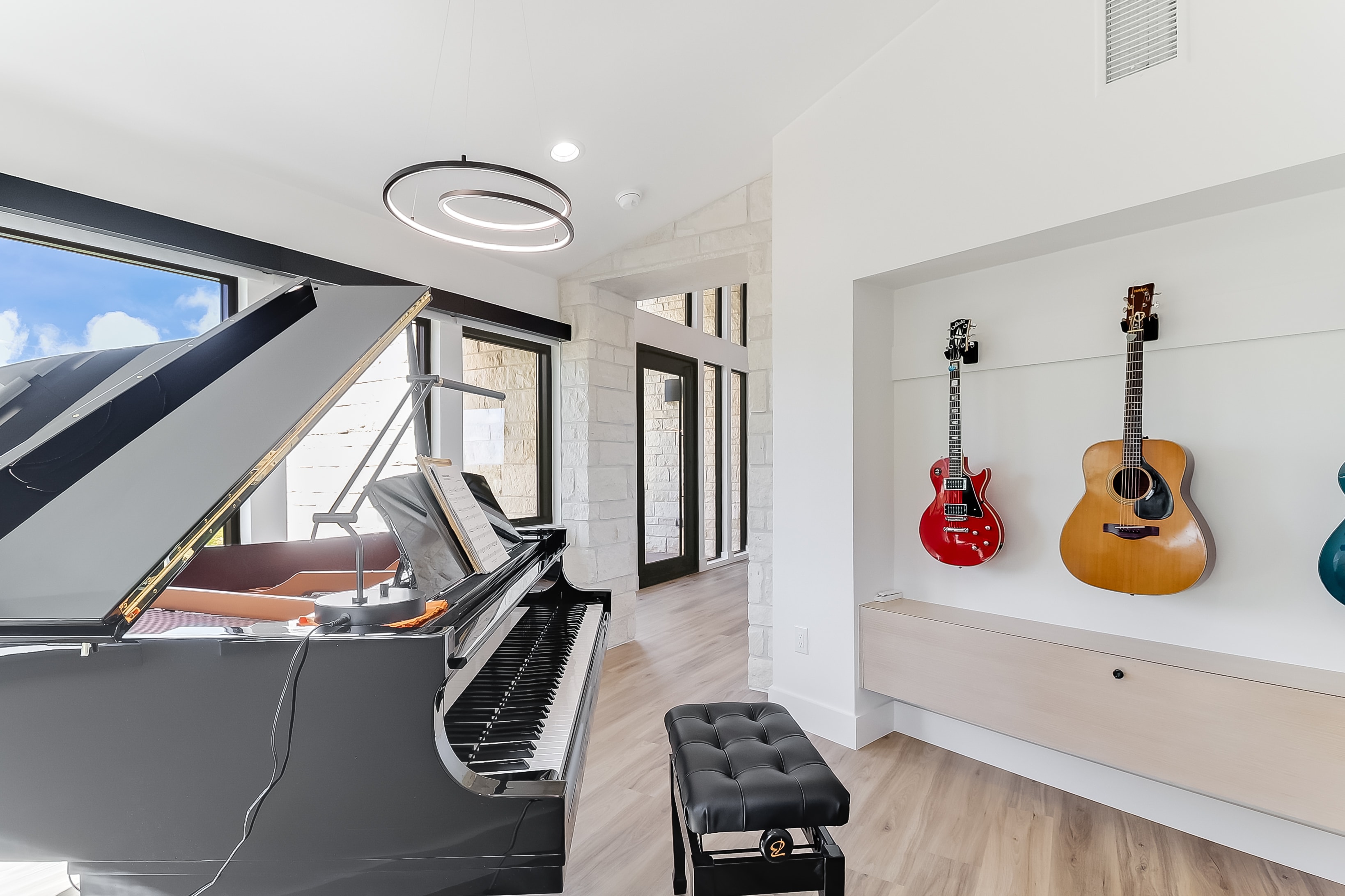 Music room with grand piano and guitar display wall, The Architect's View