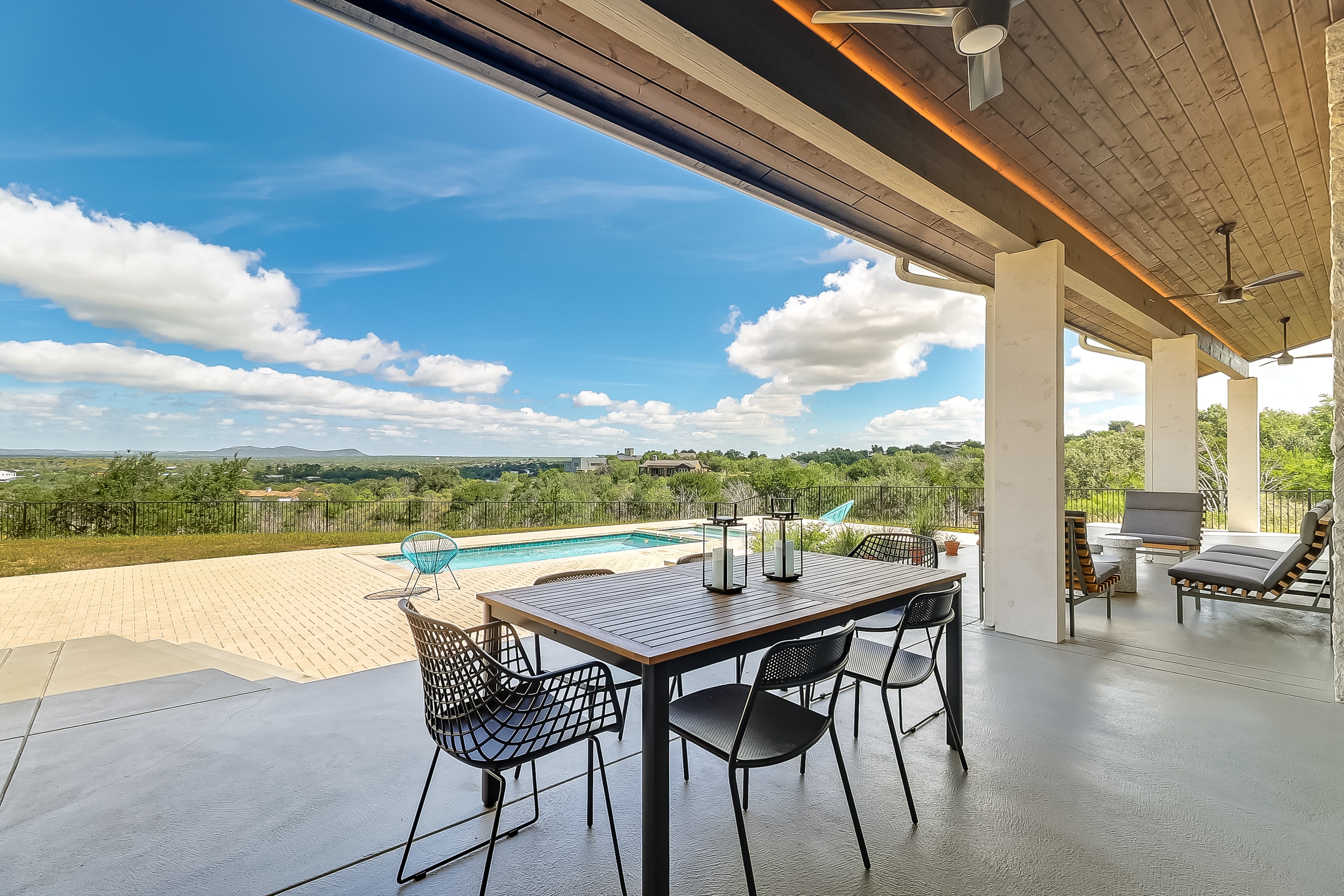 Covered patio looking outward to pool and panoramic Hill Country views, The Architect's View