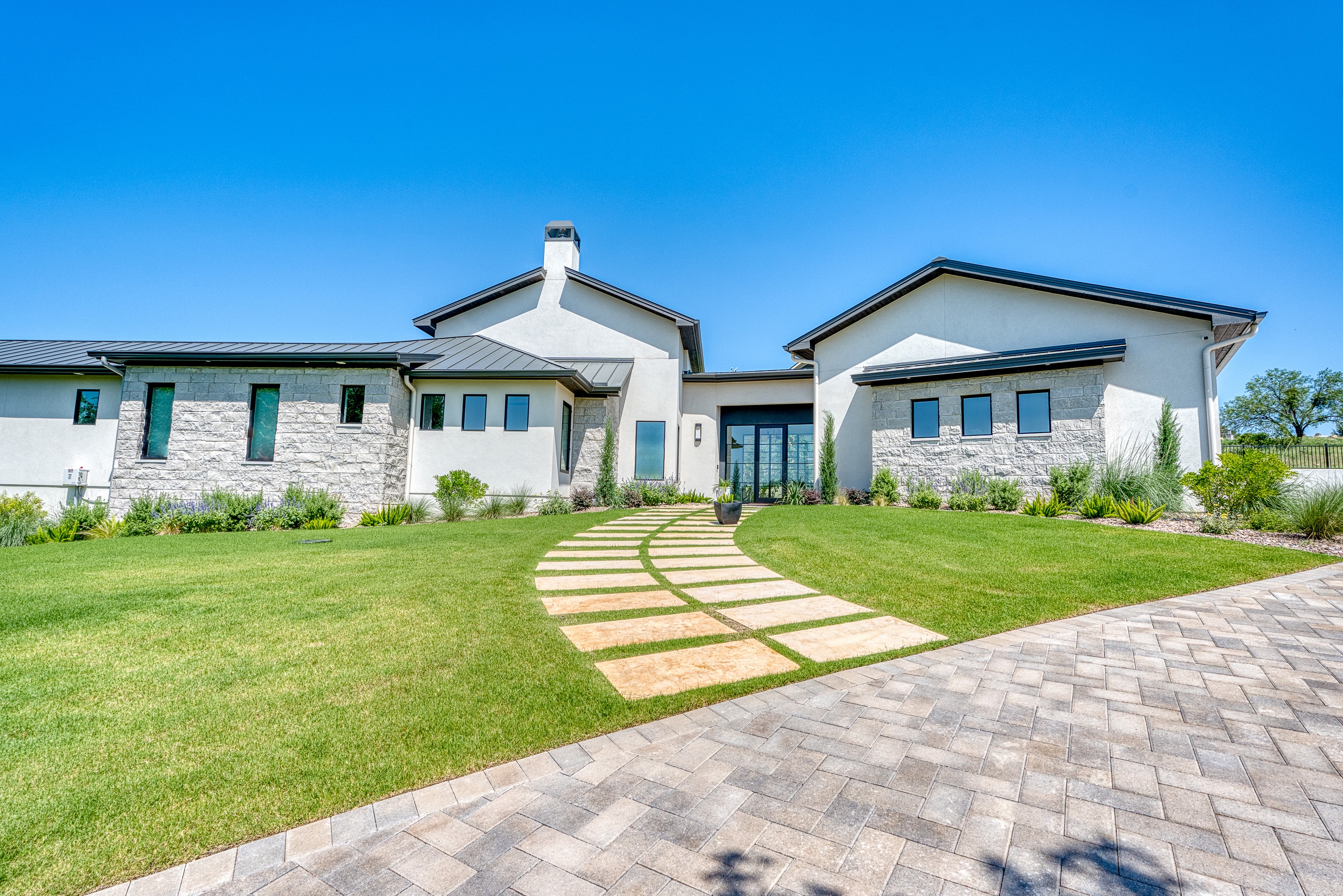 Horseshoe Bay Golf Course Retreat — curved stone walkway and front elevation — Grubbs Construction